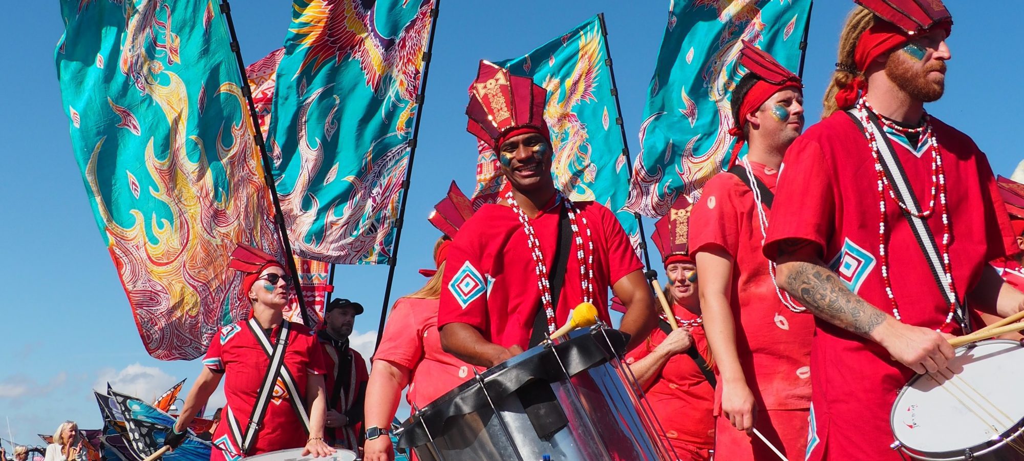 drummers in a parade with flags