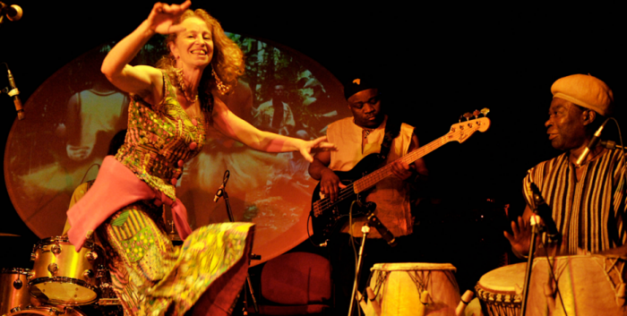 Performing group on stage with dancer at forefront