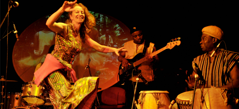 Performing group on stage with dancer at forefront