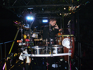 Percussionist sat amongst equipment