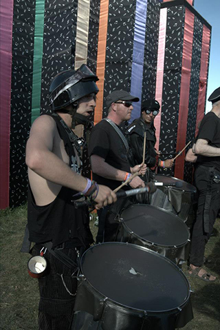 Drummers stood in a row performing