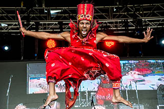 Dancer, mid-leap in red costume