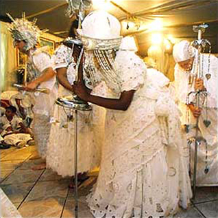 Dancers performing dressed in long white dresses