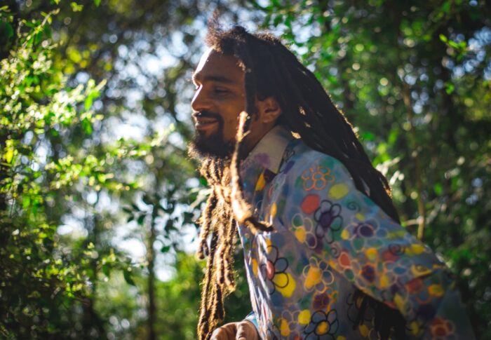 Guga, Brazilian percussionist, smiling in the sunshine is the forest