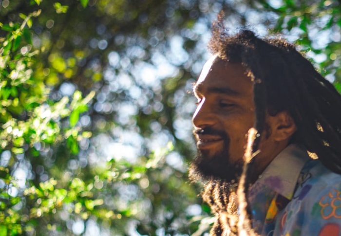 Guga, Brazilian percussionist, smiling in the sunshine is the forest