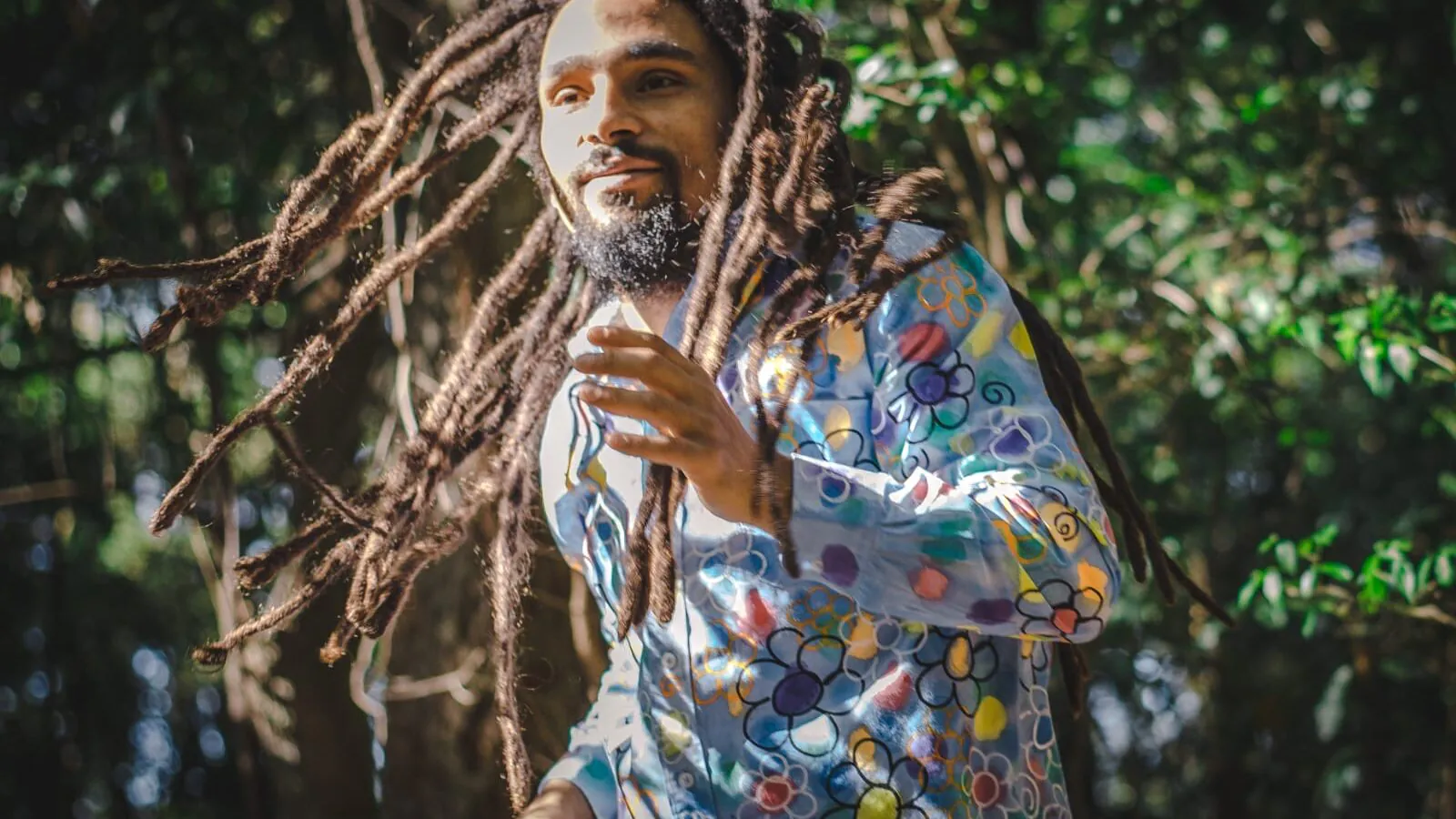 Guga, Brazilian percussionist, smiling in the sunshine is the forest