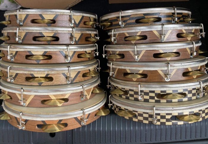 two stacks of wooden pandeiro drums