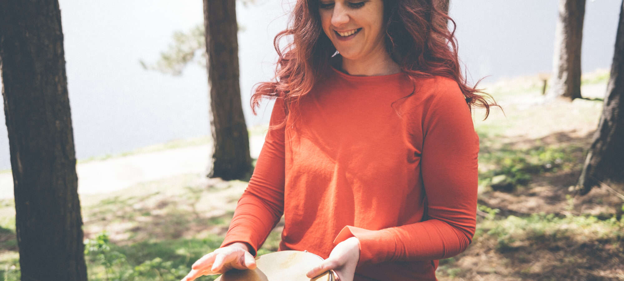 Holly percussionist playing a hand drum pandeiro
